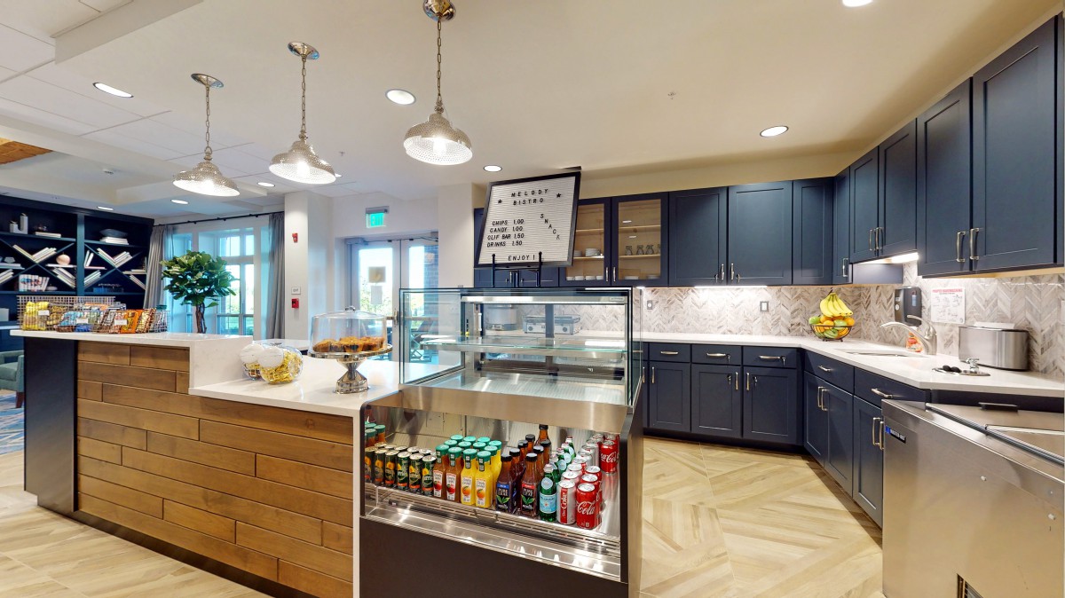 A modern kitchen interior with a beverage display and stylish lighting fixtures.