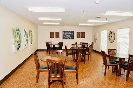 A spacious dining area featuring wooden furniture and decorative wall art.