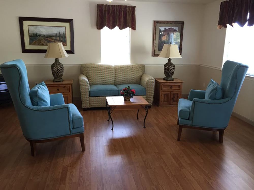 Cozy living room setup with a sofa, chairs, and decor.