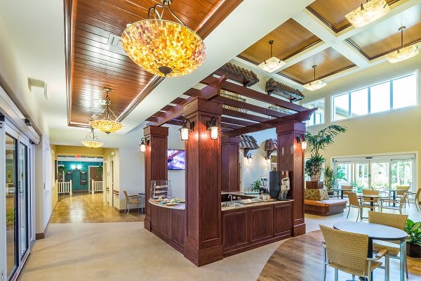 A beautifully designed lobby area featuring a wooden reception desk and ornate chandeliers.