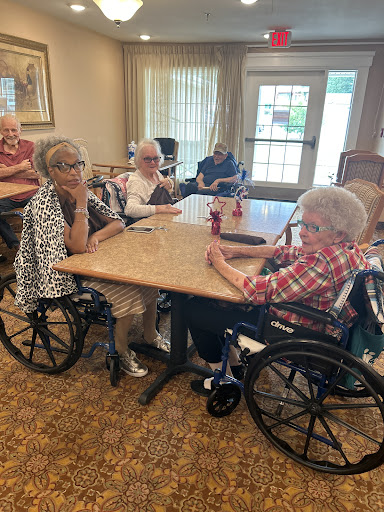 A group of elderly residents enjoying a social gathering at a community center.
