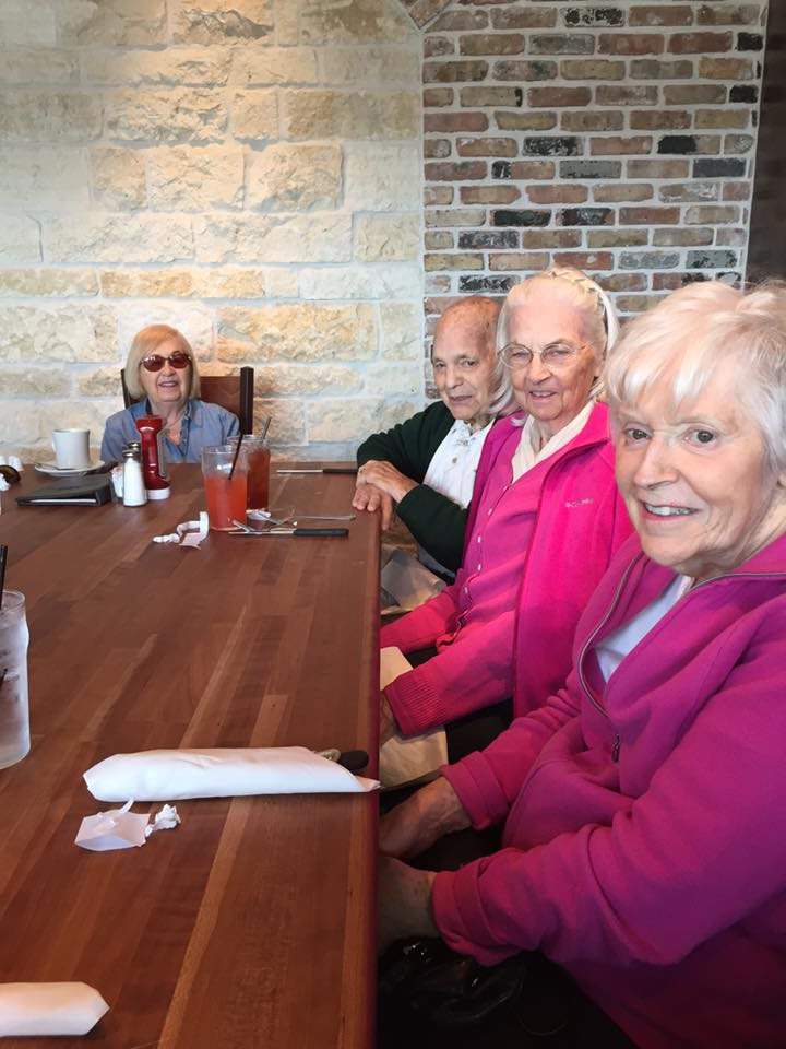 A group of seniors enjoying a meal together at a restaurant.