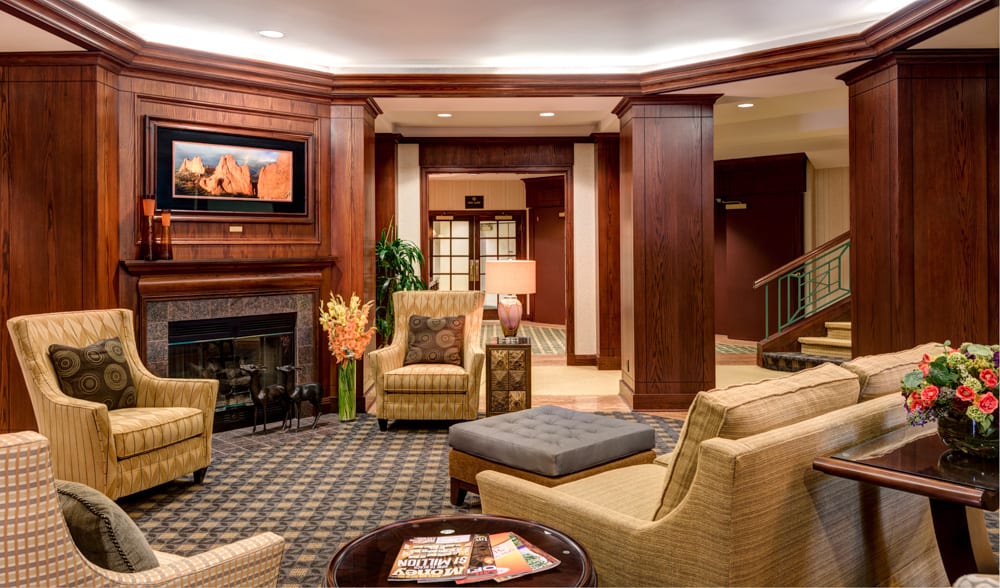 A warm and inviting hotel lobby with comfortable seating and a fireplace.
