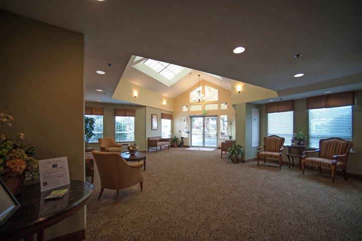 A spacious and well-lit lobby area with comfortable seating and large windows.