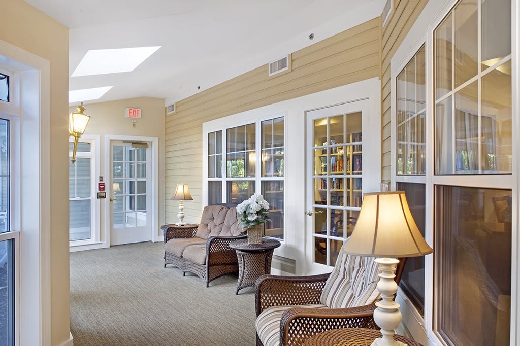 A cozy lounge area with comfortable seating and large windows.
