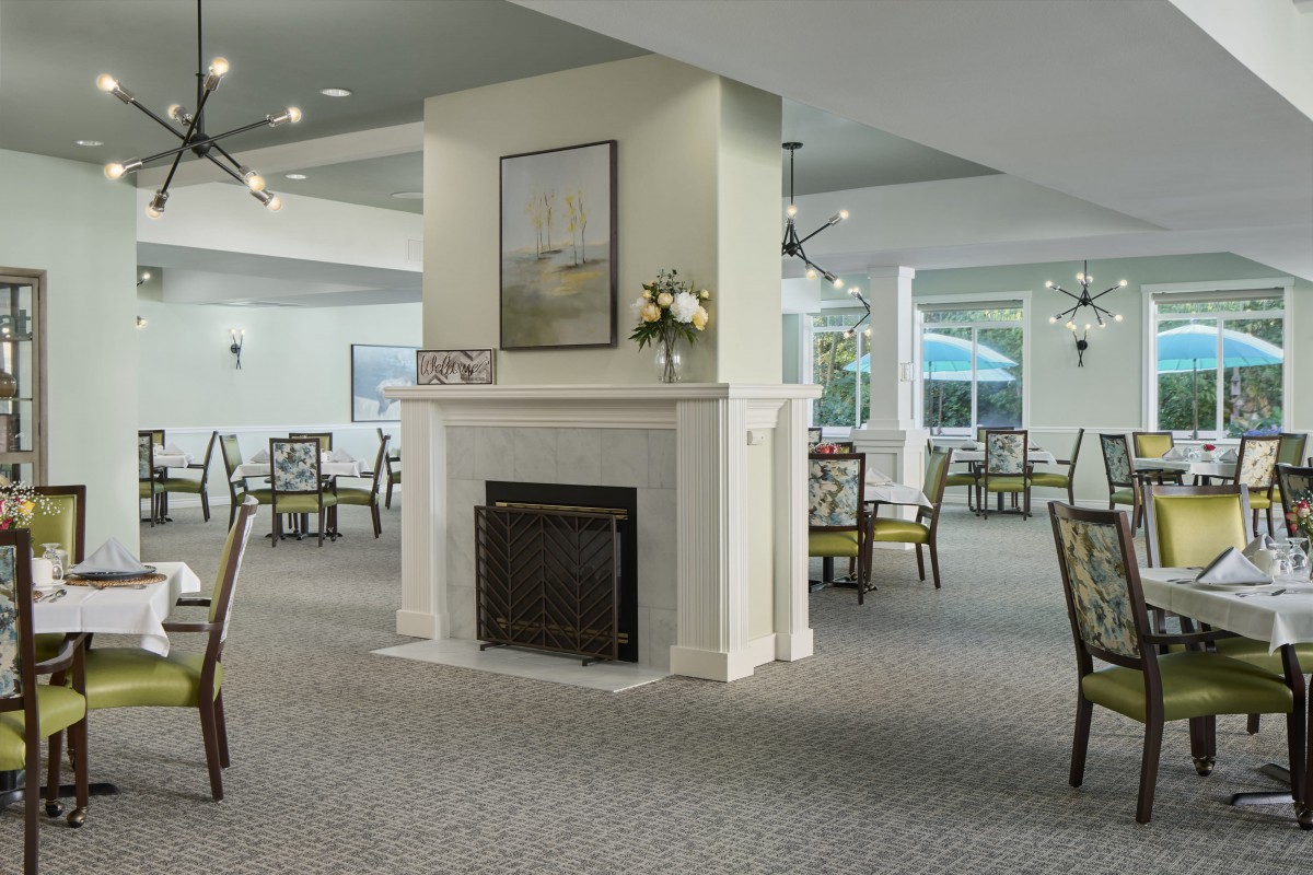 Elegant dining area with a central fireplace and stylish decor.