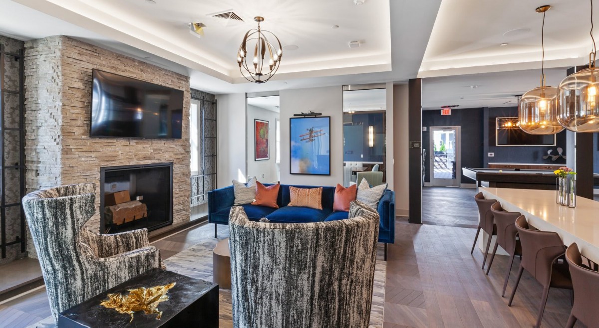 A modern living room with a fireplace, elegant seating, and stylish decor.