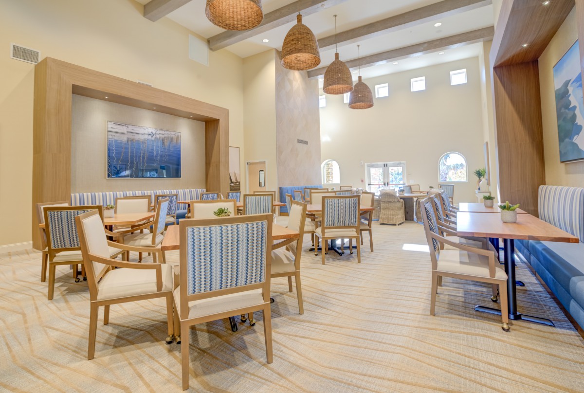 A spacious and modern dining area with comfortable seating and elegant lighting.