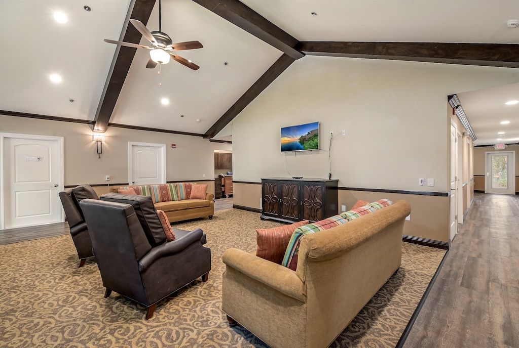A spacious living room with cozy seating and a vaulted ceiling.