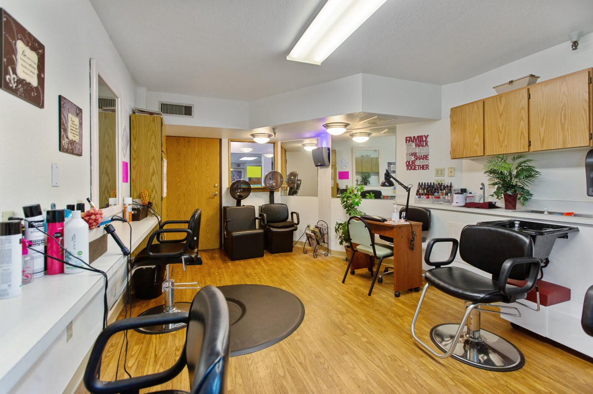 Interior view of a hair salon with styling stations and chairs.