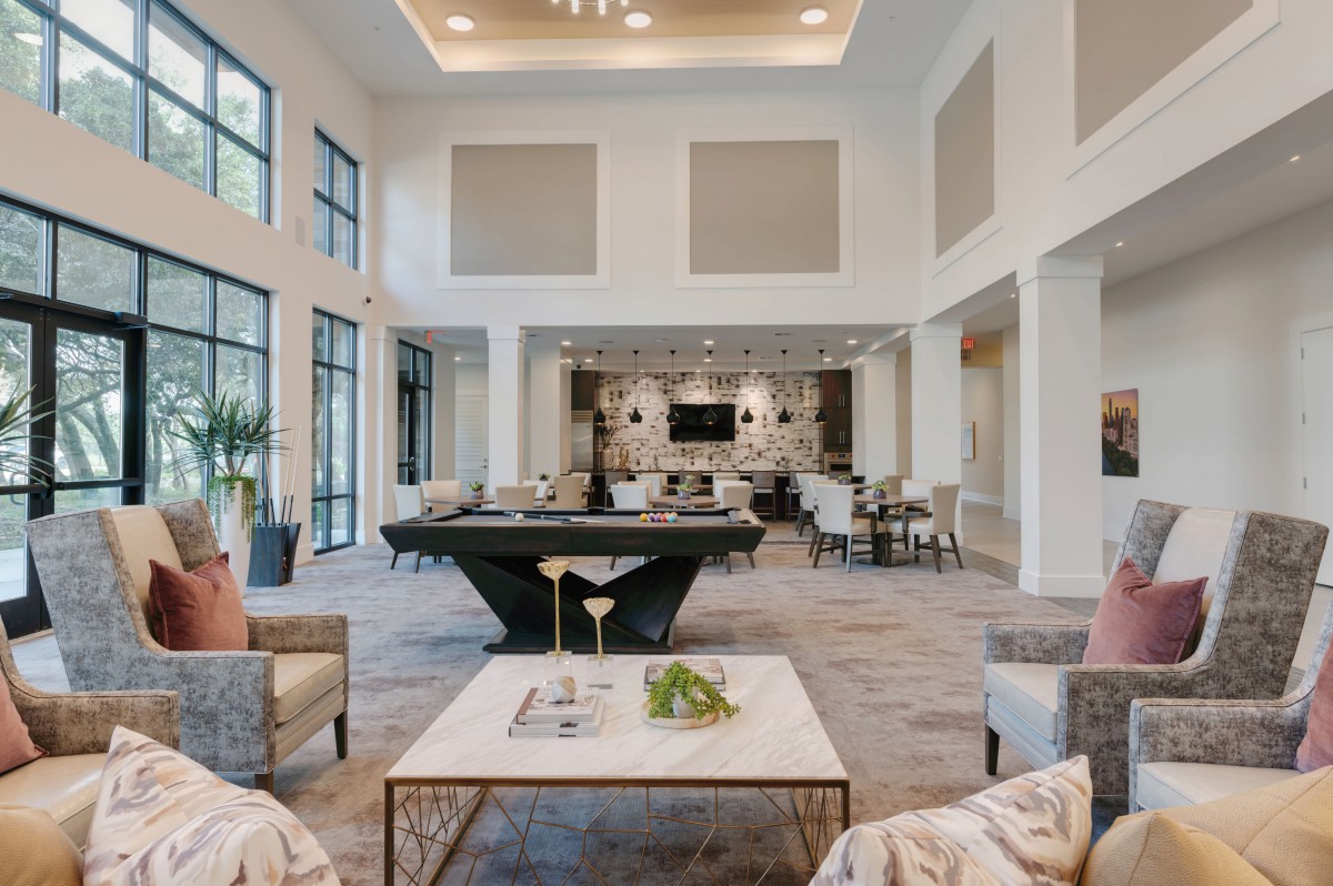 A spacious and luxurious modern living room with elegant furniture and decor.