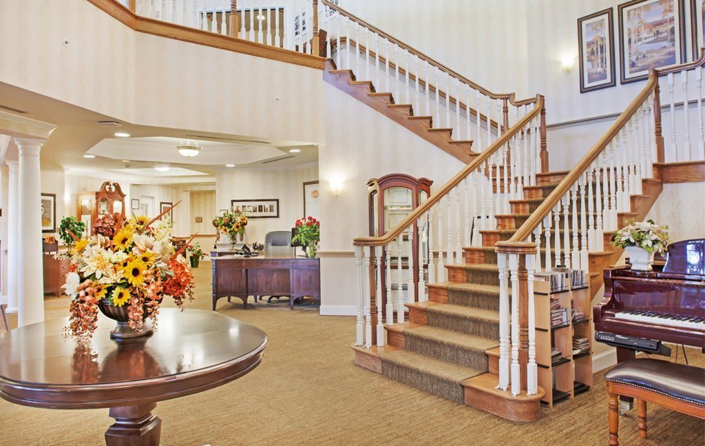 A welcoming lobby with a grand staircase and reception desk.