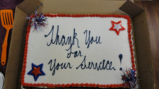 A decorated cake expressing gratitude for service.