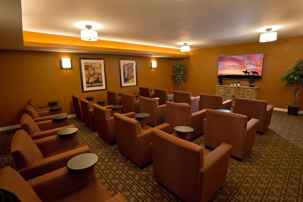 A cozy home theater with comfortable seating and a large screen.