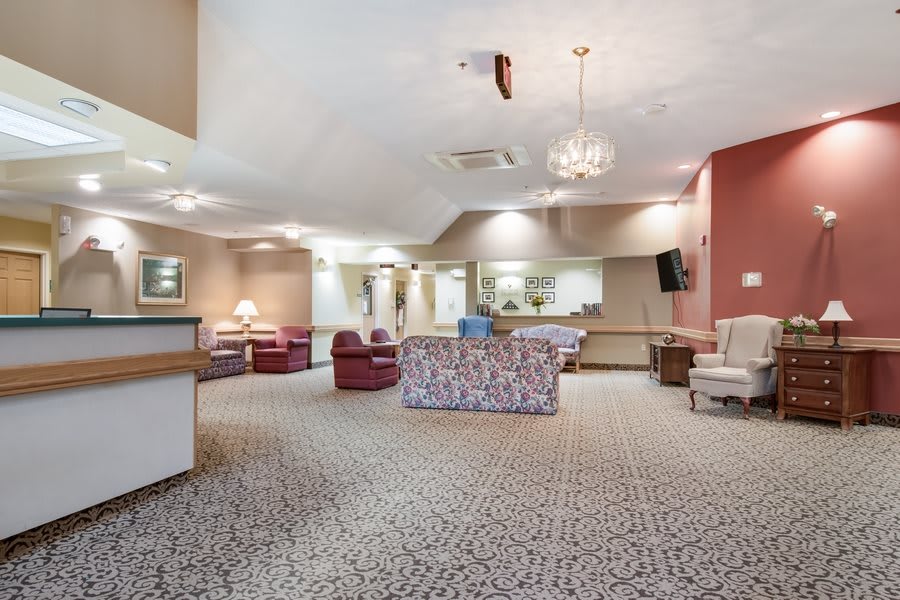 A spacious lounge area featuring comfortable seating and elegant lighting.