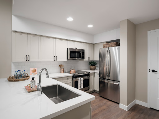 A sleek and modern kitchen featuring stainless steel appliances, elegant cabinetry, and a spacious countertop.