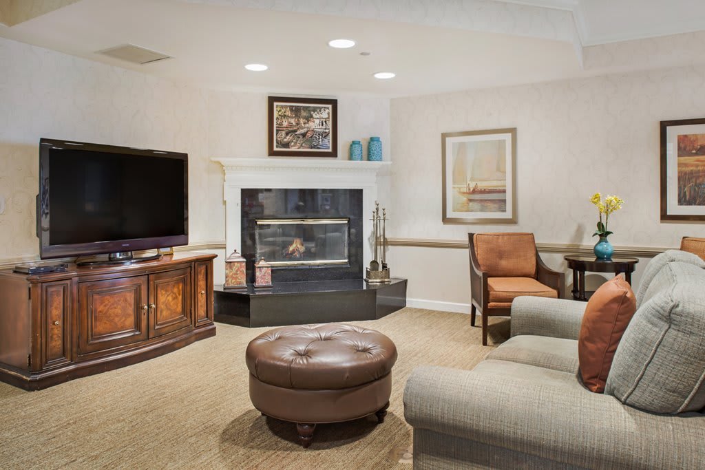 A cozy living room with a fireplace, television, and comfortable seating.