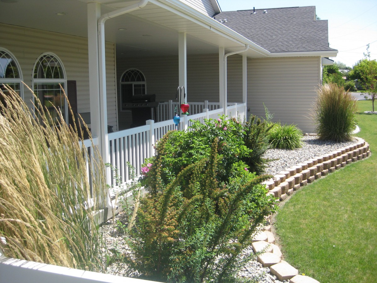 A well-maintained garden and porch area with lush greenery.