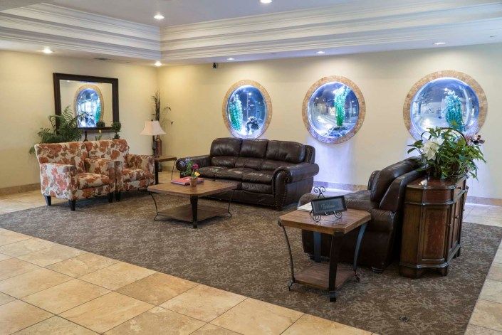 A cozy lobby with comfortable seating and decorative windows.