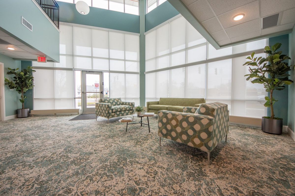 A modern lobby with stylish furniture and abundant natural light.