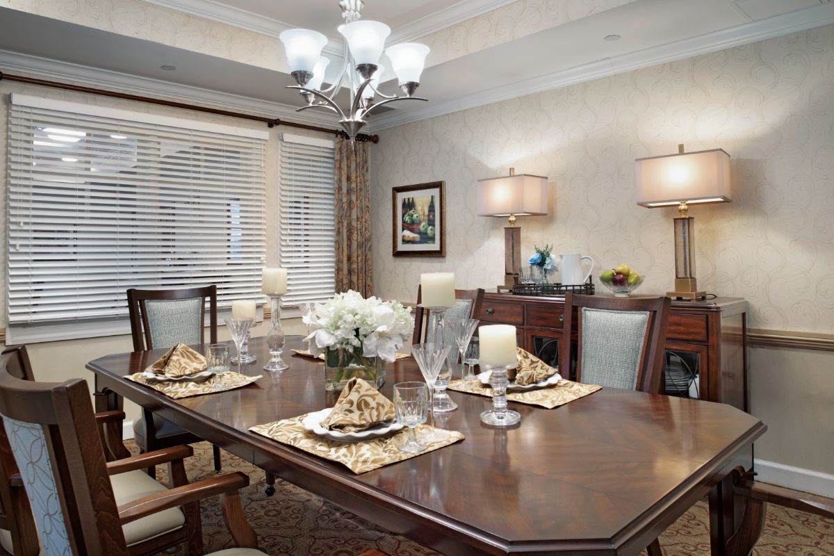 A beautifully decorated dining room with an elegant table setting and chandelier.