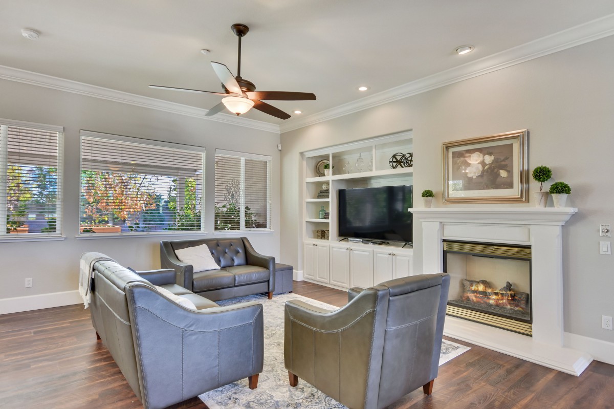 A modern living room with comfortable seating, a fireplace, and a large television.