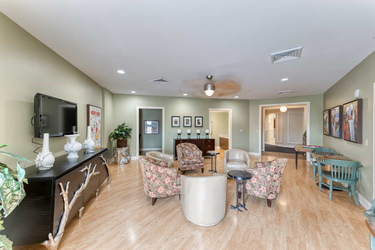 A modern living room with stylish furniture and wooden flooring.