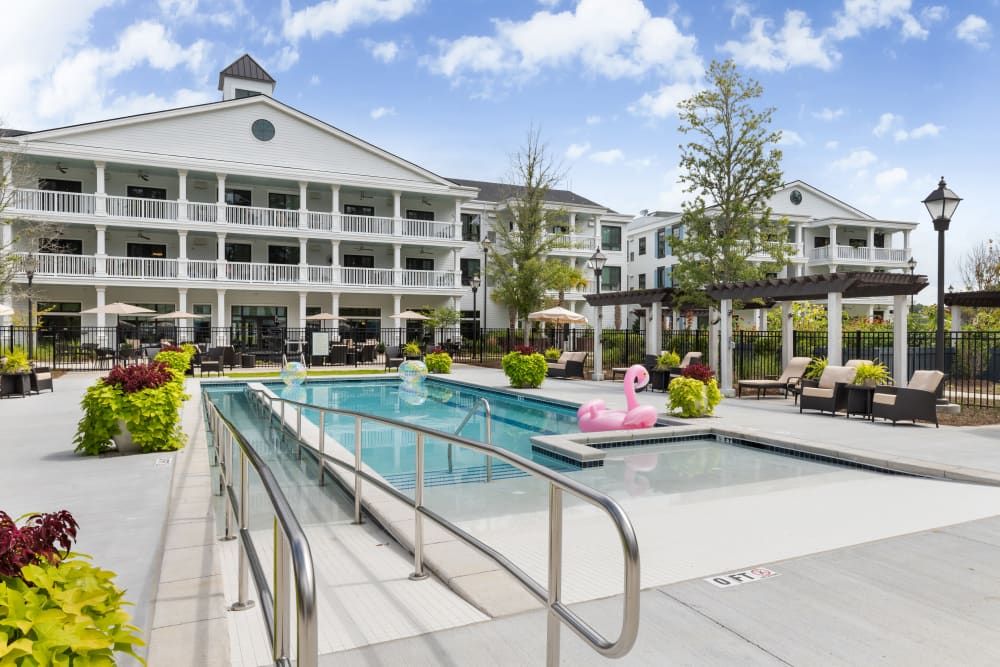 A luxurious hotel with an inviting outdoor swimming pool area, perfect for relaxation.