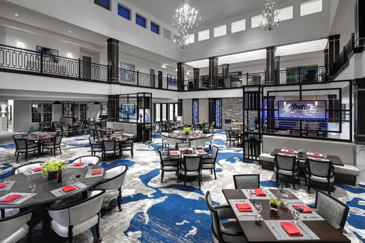 A luxurious and modern restaurant interior with elegant chandeliers and stylish seating arrangements.