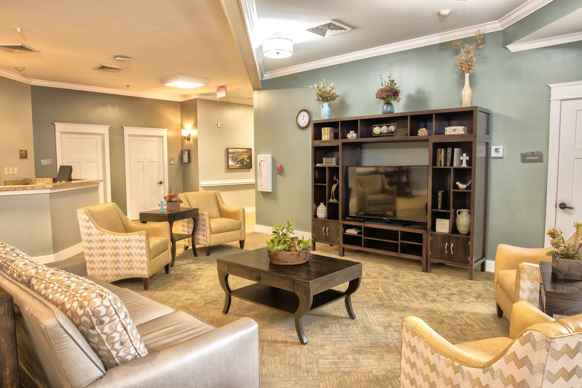 A cozy living room with modern furnishings and a television center.