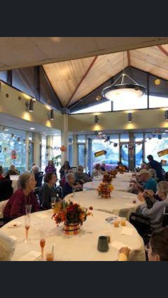 A group of people gathered at a decorated venue for a celebration.