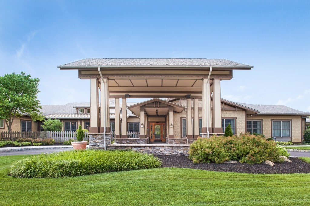 A modern building entrance with a landscaped garden.
