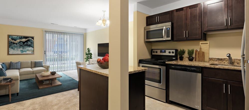 A modern kitchen with stainless steel appliances and an adjacent dining area in an open layout design.