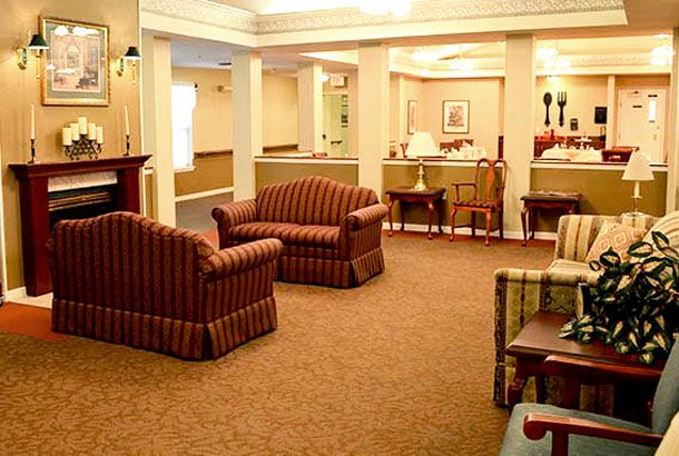 A cozy lobby area with sofas, chairs, and tables arranged for comfort.