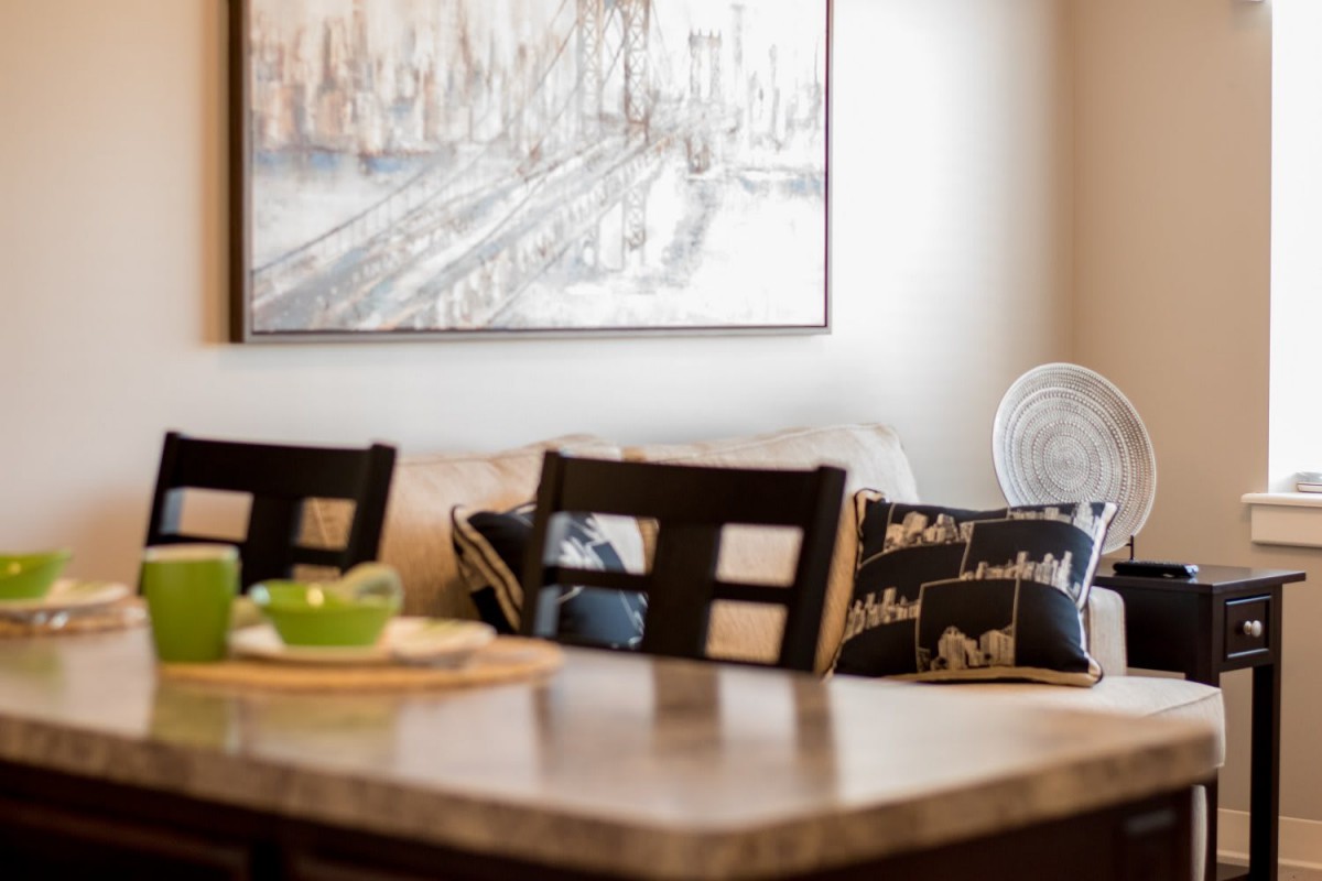 A cozy dining area with a stylish table, chairs, and decorative artwork.