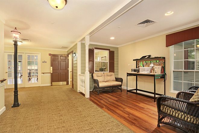 Cozy living room with wood flooring and comfortable seating near the entrance.
