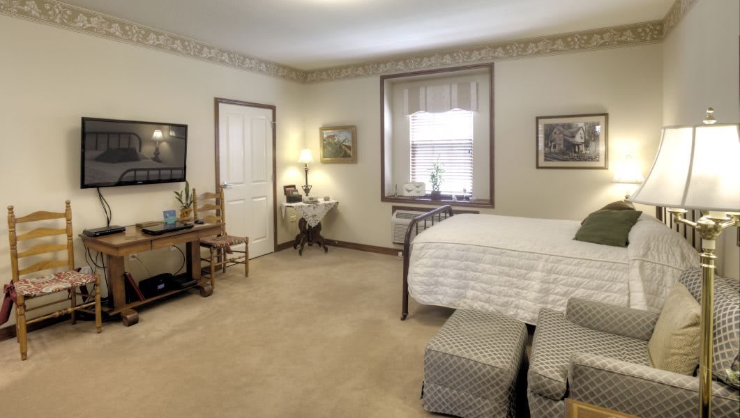 A cozy bedroom with neutral tones and classic furnishings.