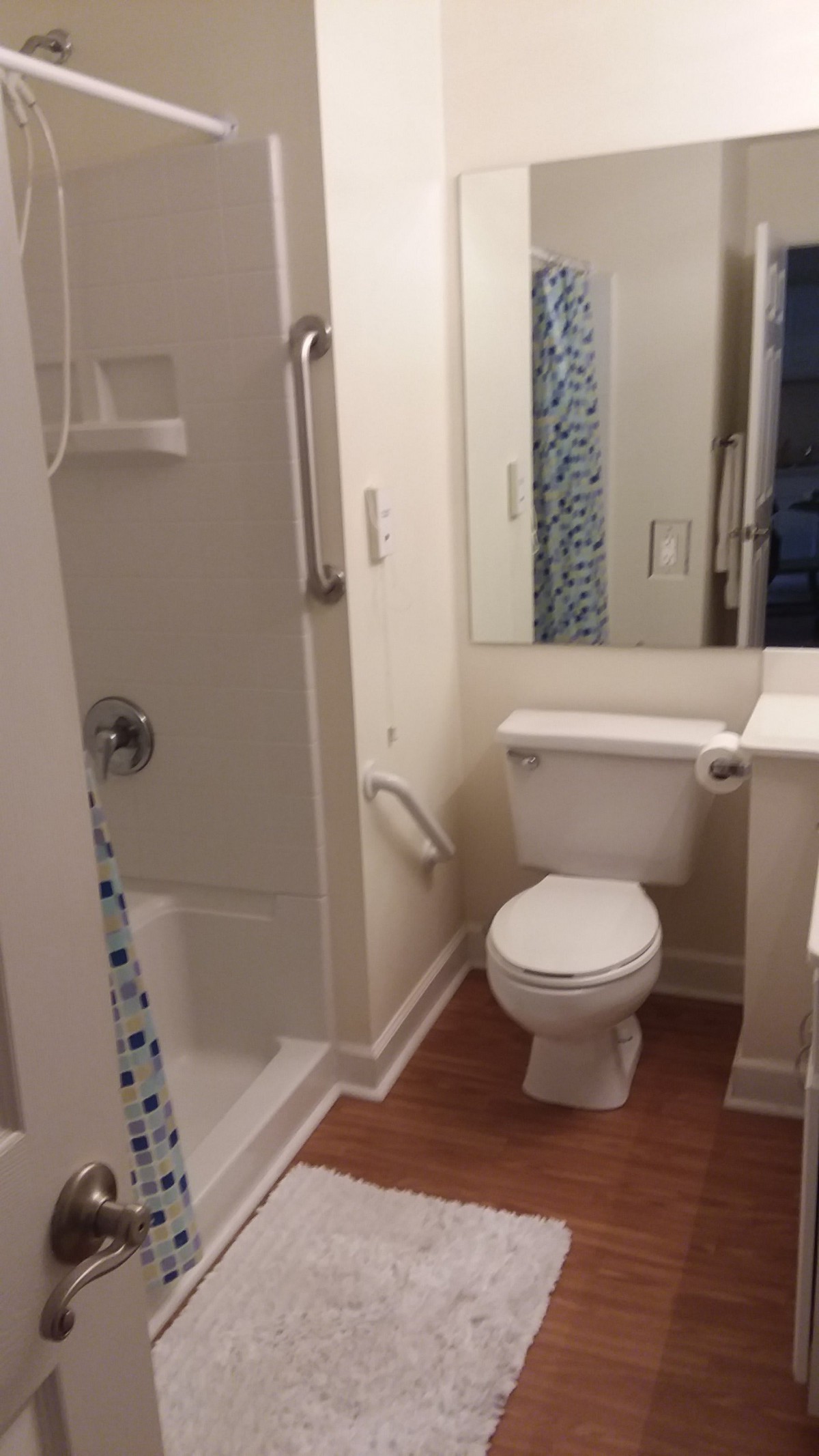 A clean and simple bathroom with a shower and toilet.