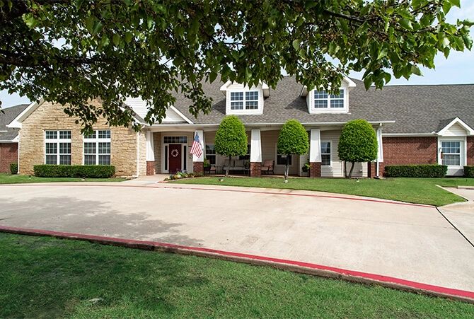 A suburban house with a driveway and well-maintained yard.