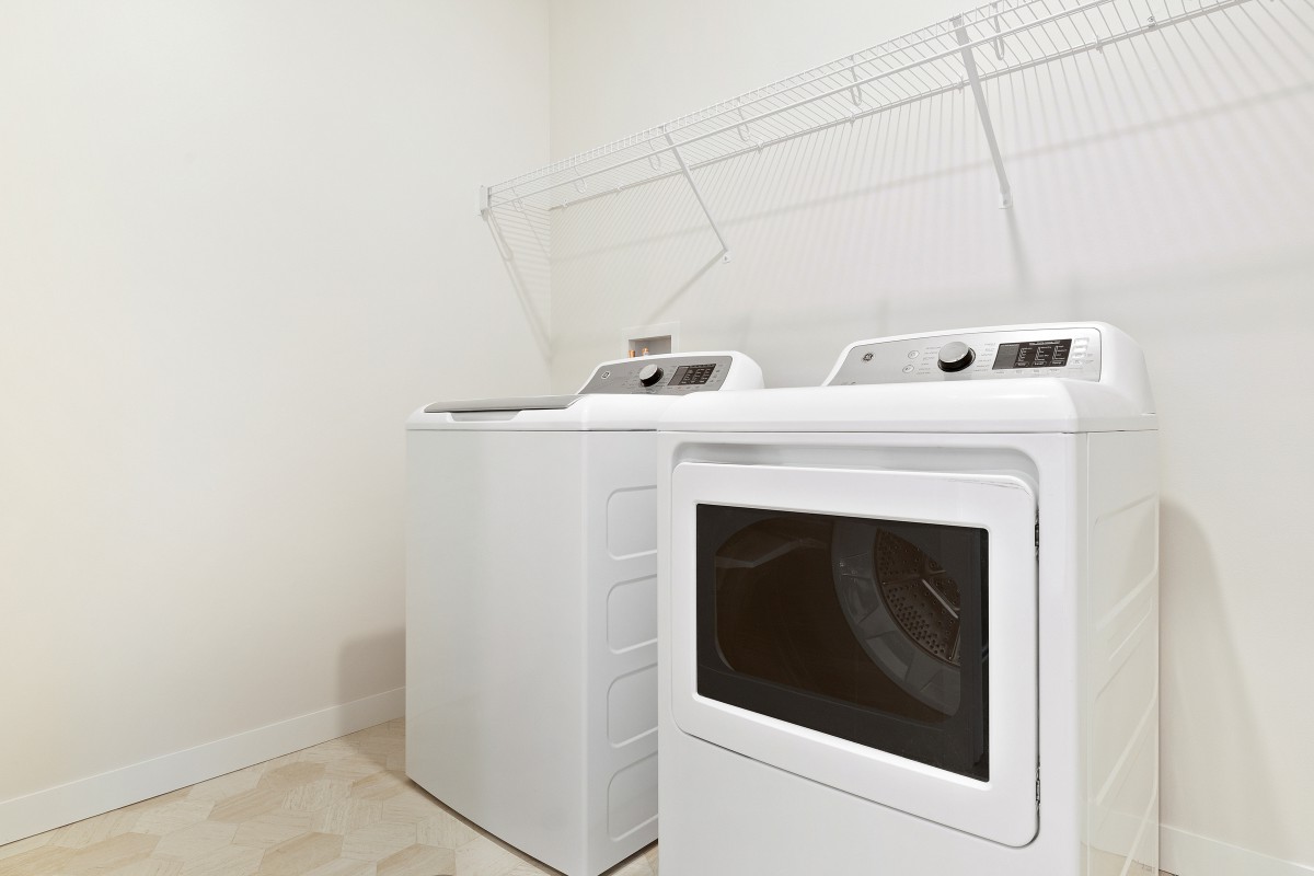 A clean and modern laundry room featuring a washing machine and dryer.