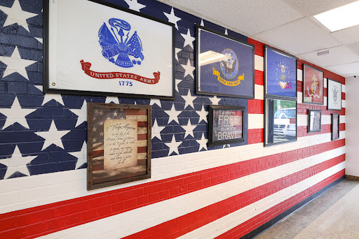 A vibrant wall display featuring American military symbols and a flag background.