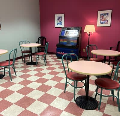 A vintage-style diner with checkered floors and a jukebox.