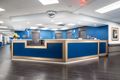 A modern office reception area with blue walls and sleek design.