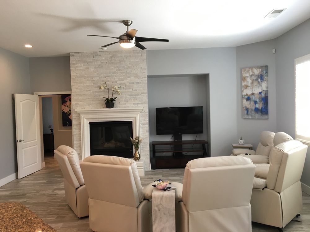 A modern living room with a fireplace, television, and comfortable seating arrangement.