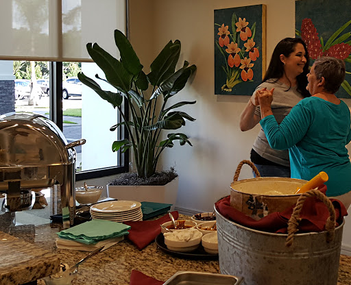 A lively gathering featuring food and conversation in a decorated space.