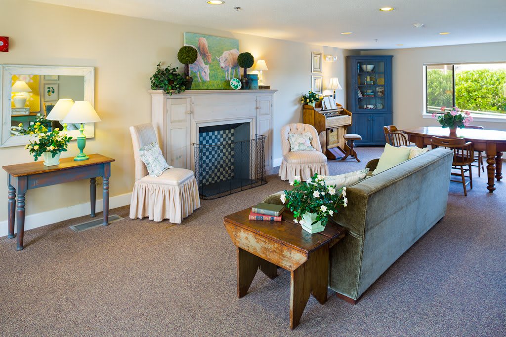 A cozy and elegantly decorated living room featuring a fireplace, comfortable seating, and tasteful decor.
