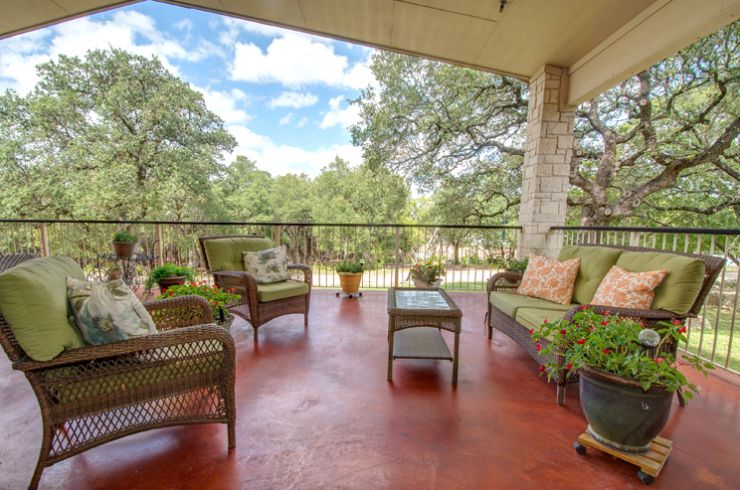 A cozy patio with outdoor seating offering a relaxing nature view.