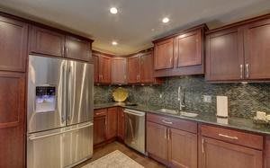 Modern kitchen with wooden cabinets and stainless steel appliances.