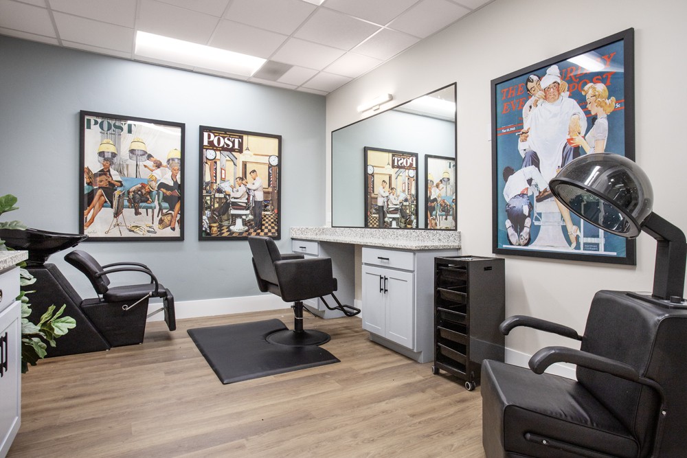 A modern and clean hair salon interior with stylish artwork and comfortable seating.