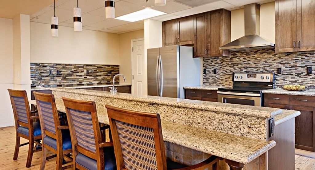 Modern kitchen with granite countertops and stainless steel appliances.